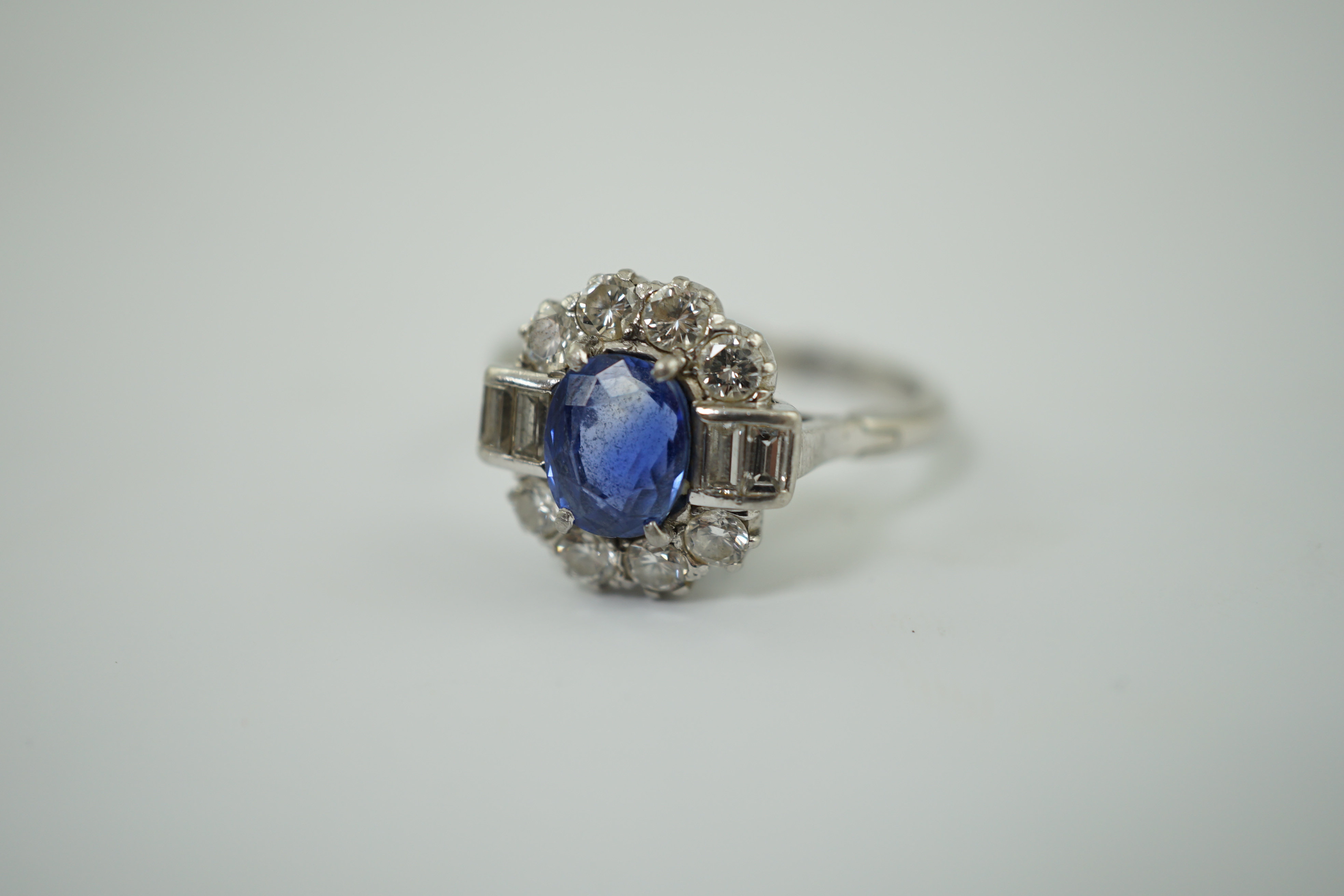 An Art Deco style platinum?, sapphire and diamond cluster ring
